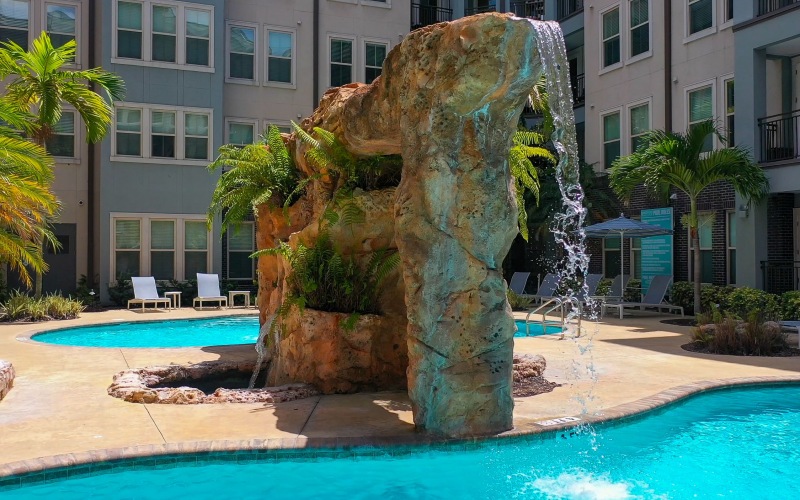 Apartment pool with rock waterfall at Novus Westshore